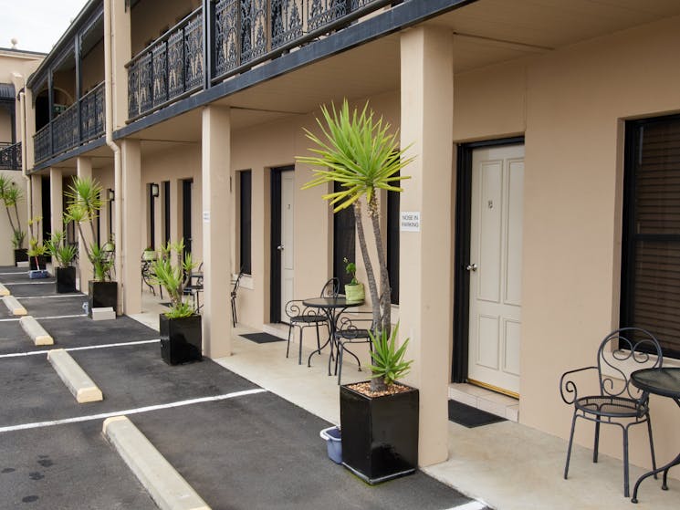 Front lower level of motel looking toward room entrances