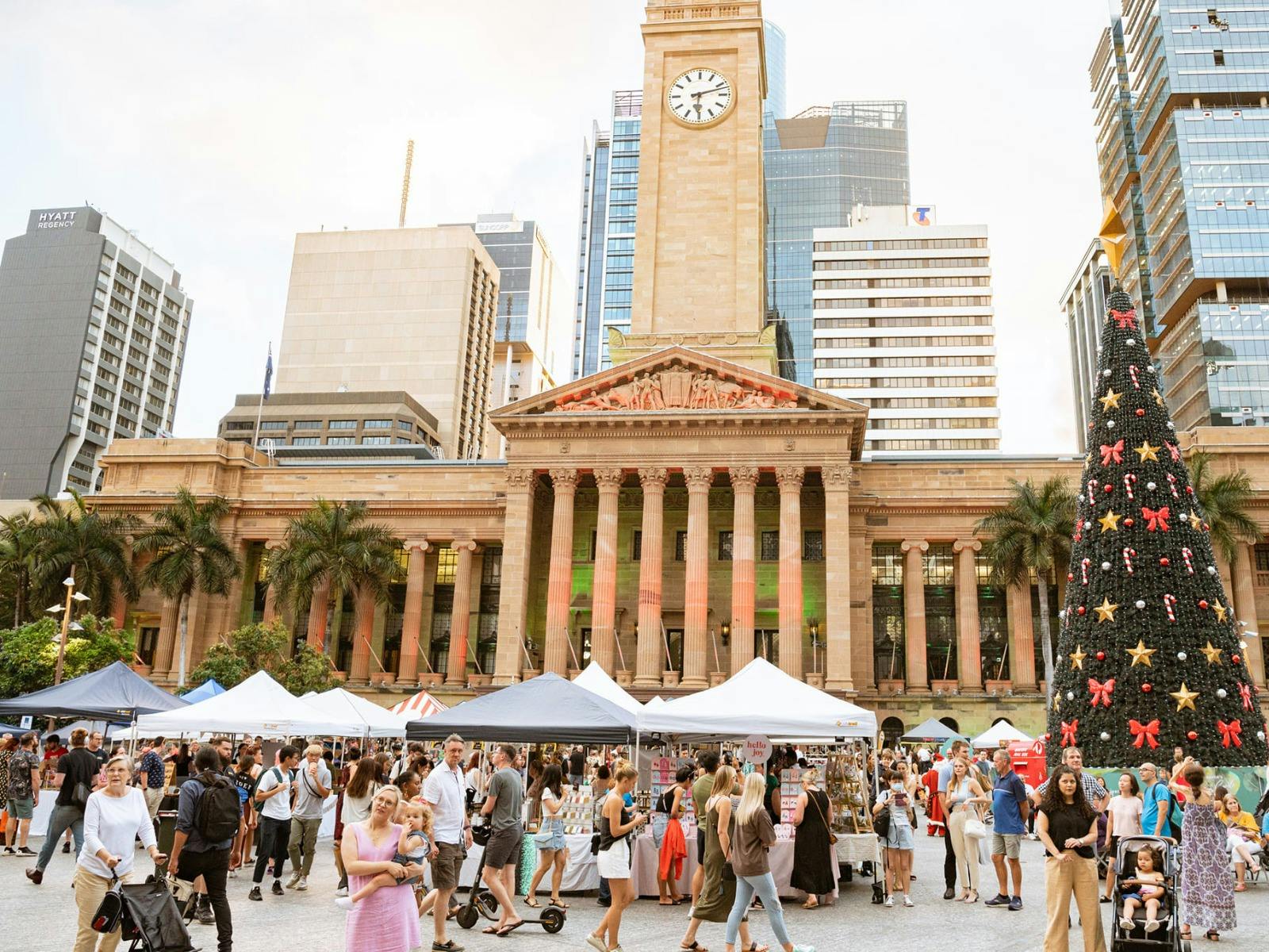 A photo of the Market set up infront of Brisbane City Hall with the Christmas Tree