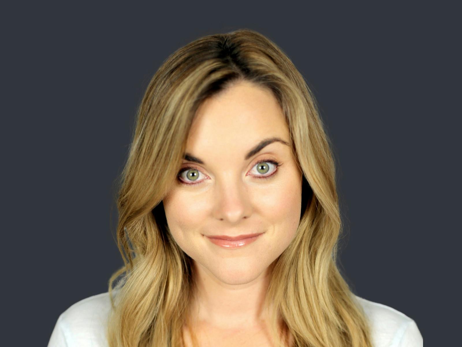 headshot of blonde lady on dark blue background