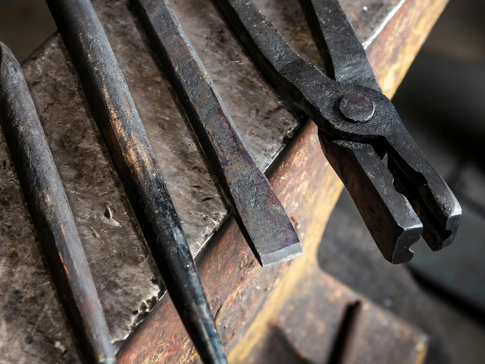 Blacksmithing tools resting on anvil.