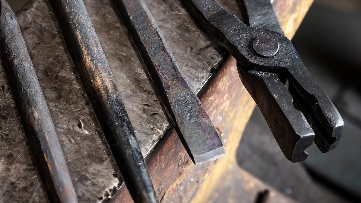Blacksmithing tools resting on anvil.