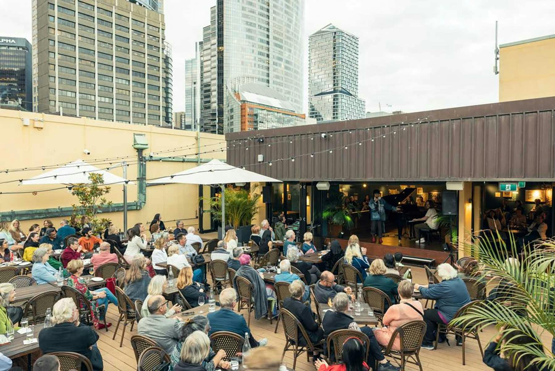 A crowded rooftop bar