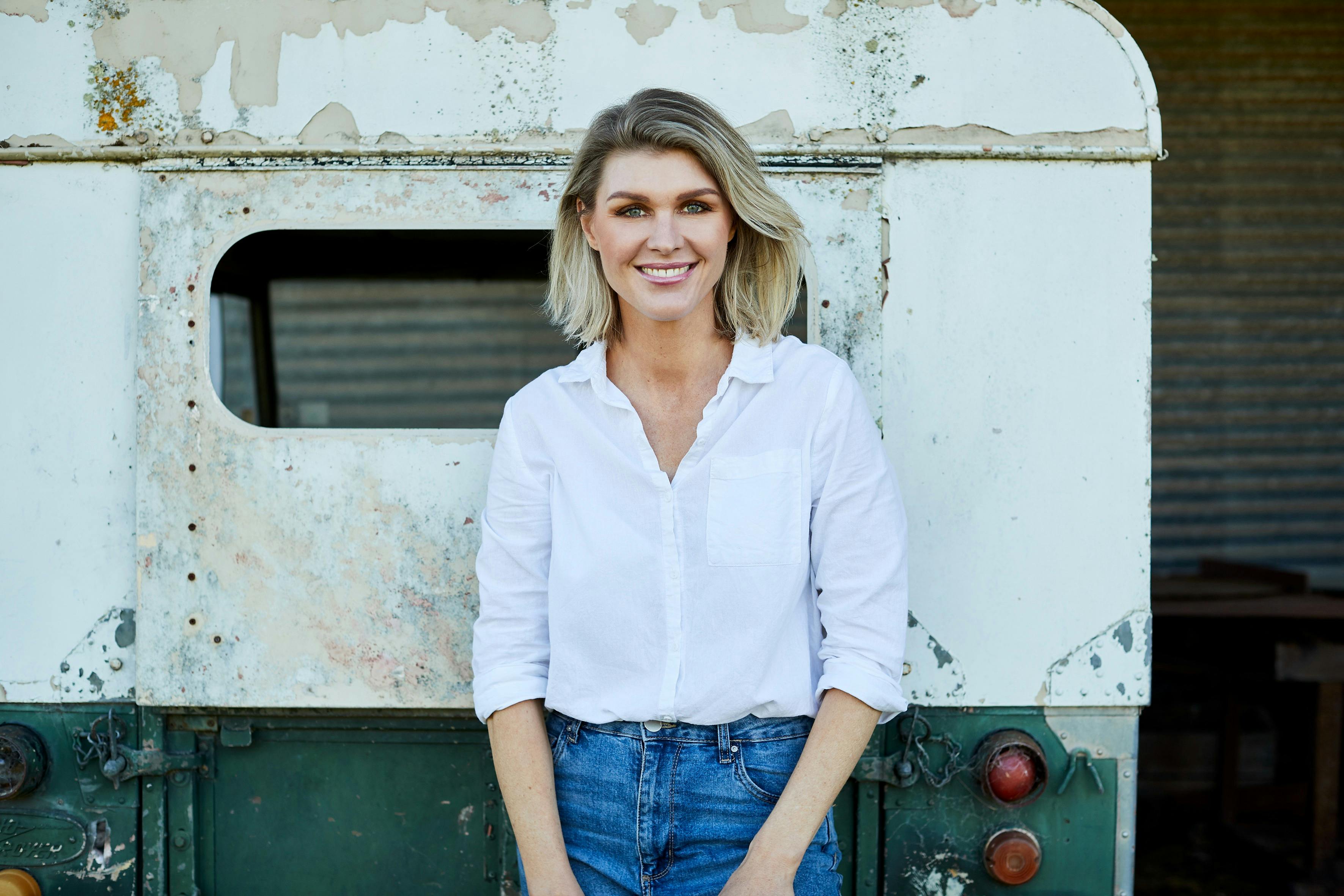Courtney Roulston standing against a wall