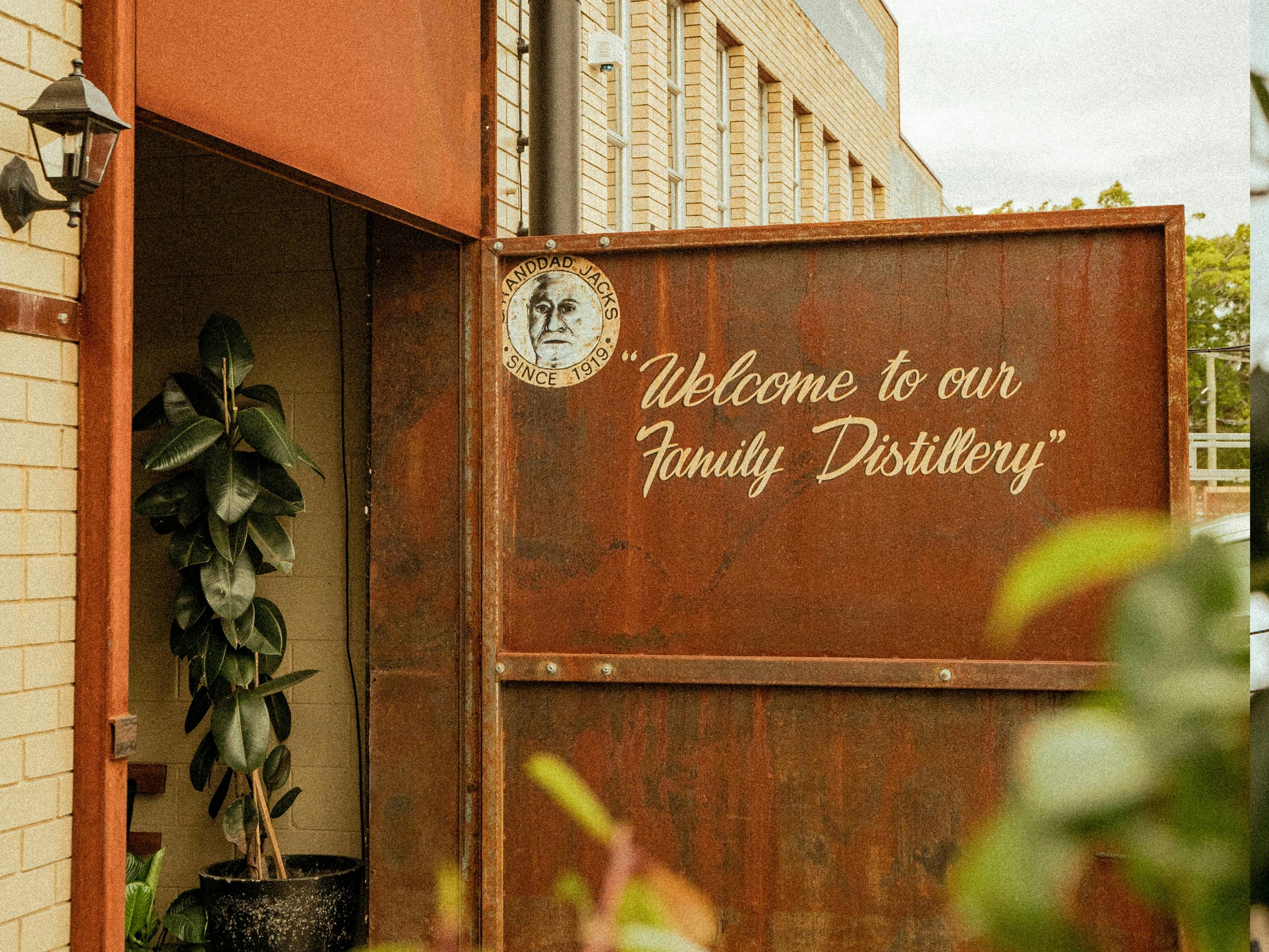 The steel gate open and welcoming people to our family distillery.