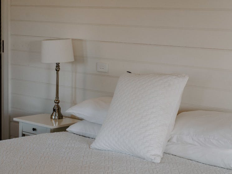 Master bedroom large bed, white linen and white walls