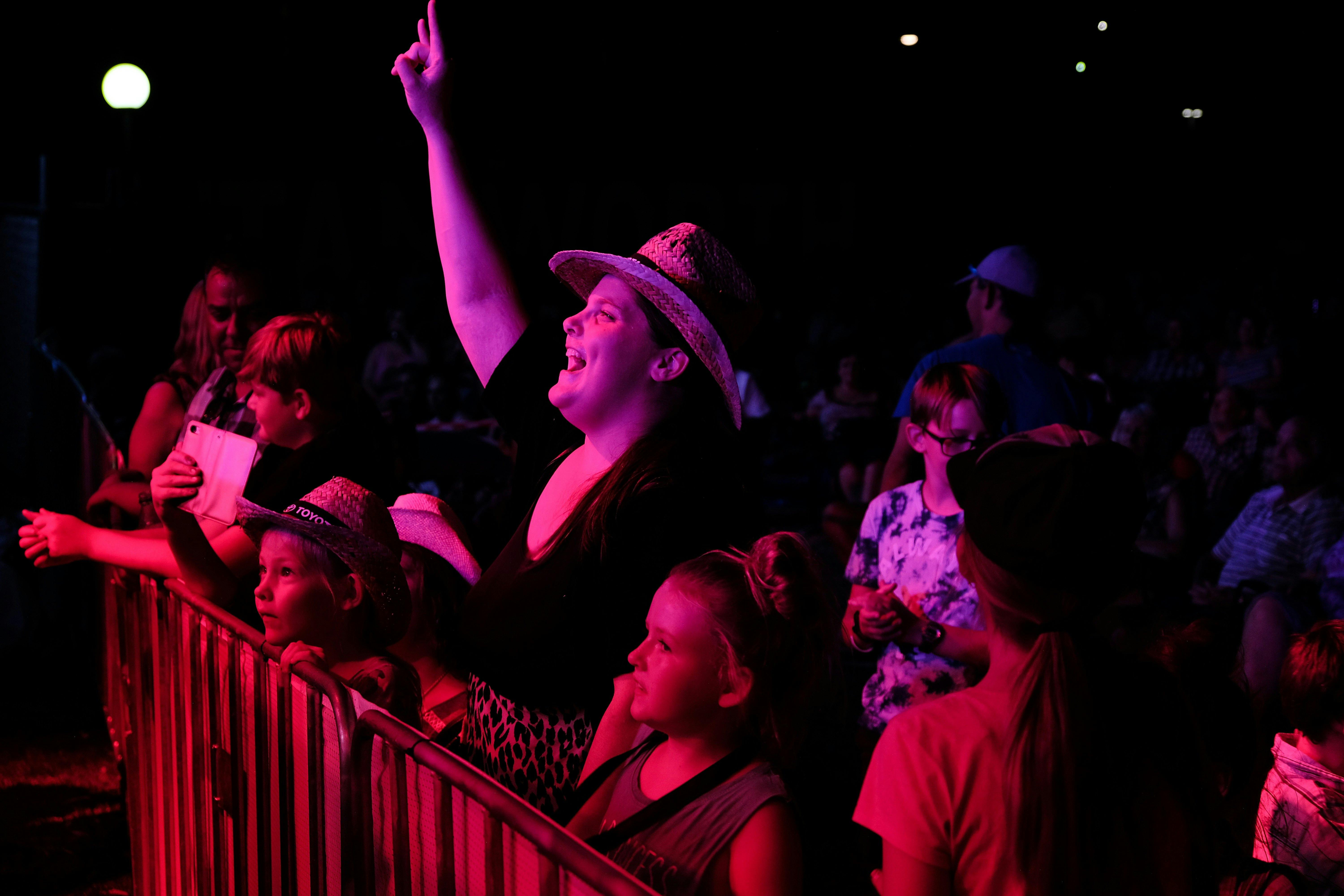 Woman enjoying music at Toyota Park with children during Tamworth Country Music Festival