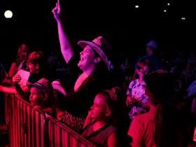 Woman enjoying music at Toyota Park with children during Tamworth Country Music Festival