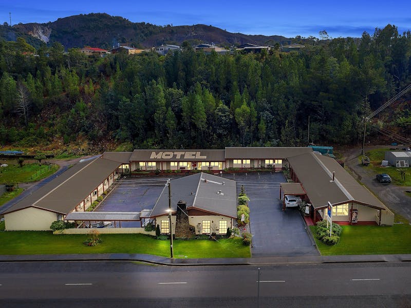 The motel is nestled within a back drop of pine trees and Mount Owen at the front