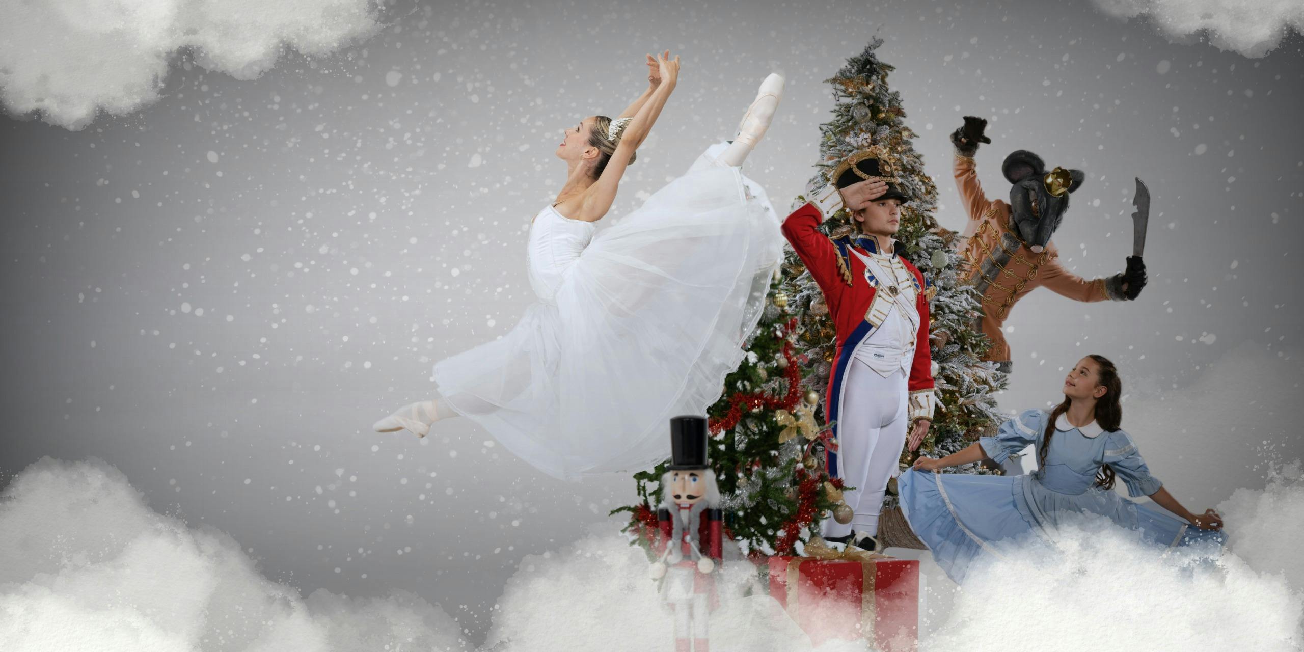 A Ballerina in a white dress, a boy dressed as a nutcracker and a person dresses as a mouse