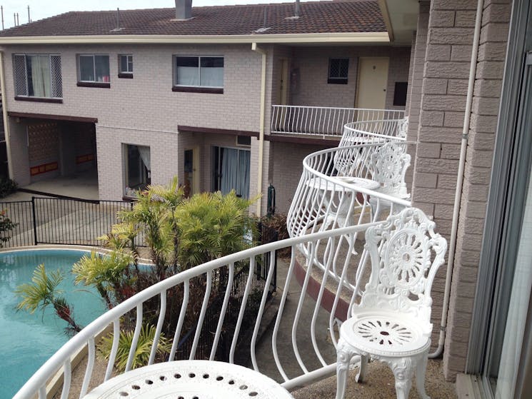 Upstairs rooms feature balconies overlooking the pool