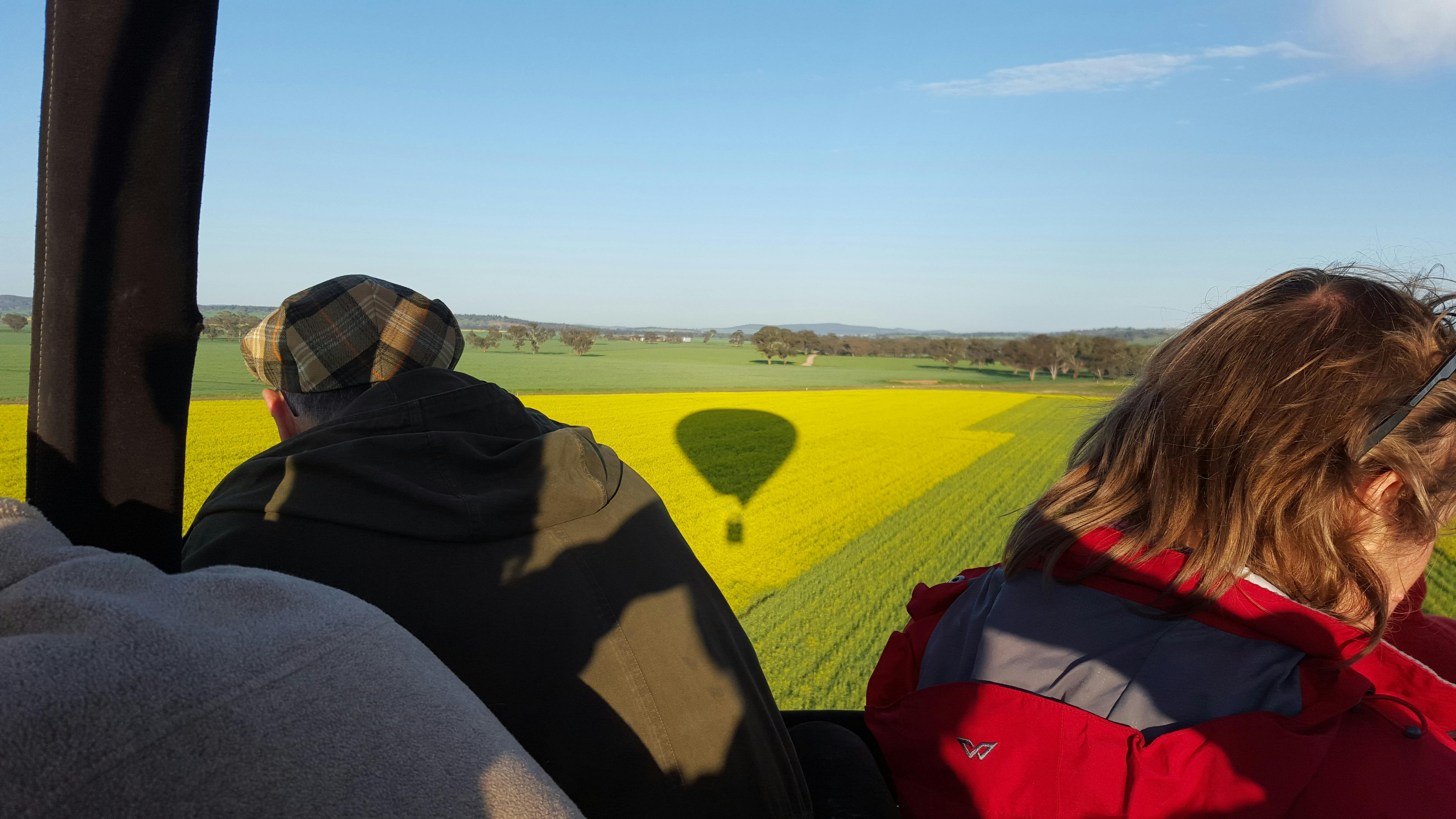Balloon shadow over canola fields