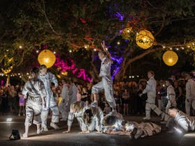 Acrobats and aspiring acrobats (children) perform in Festival Park, Darwin Festival