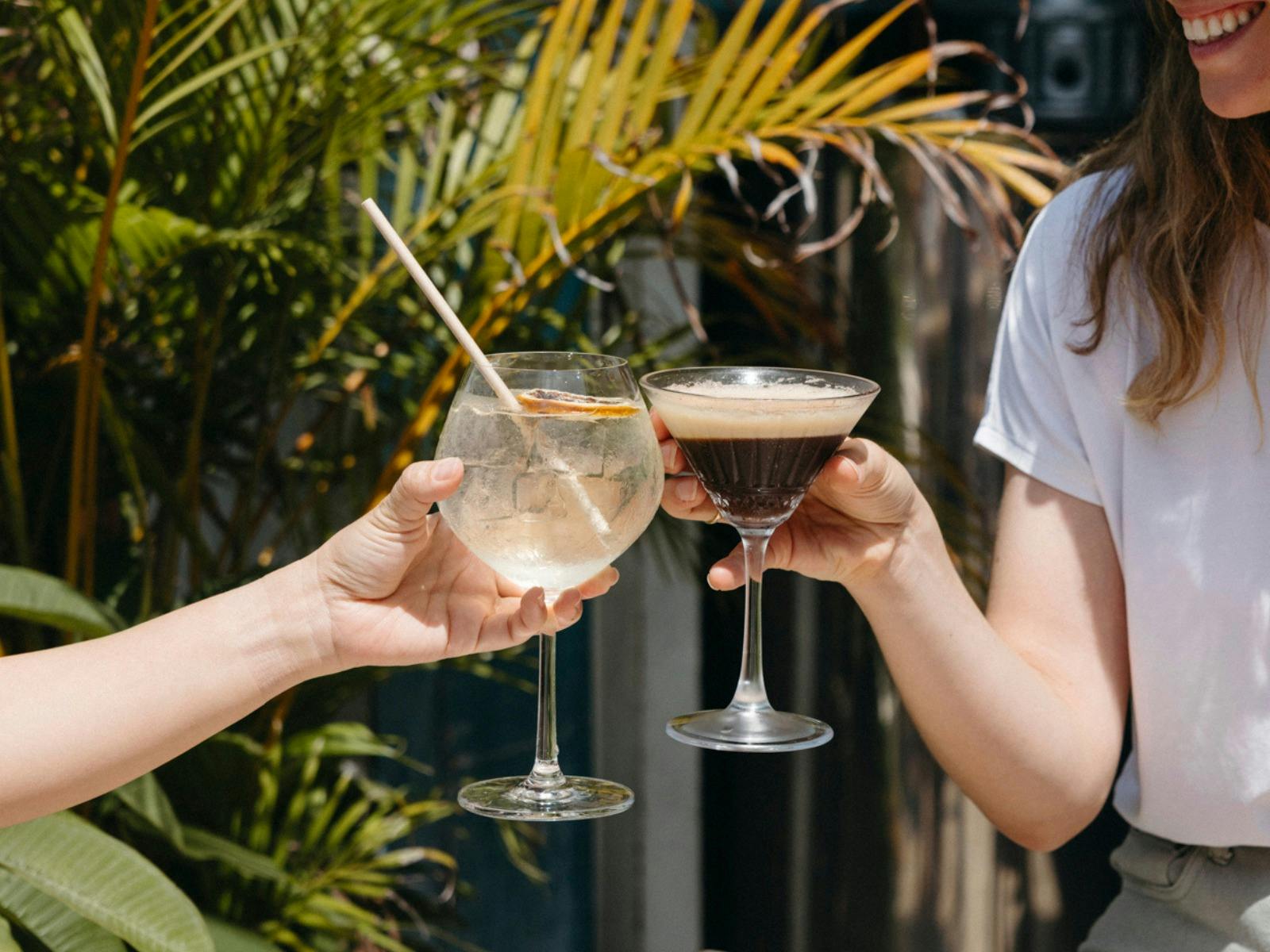 Two people drinking a limoncello spritz and a espresso martini at Hang 10 Distillery