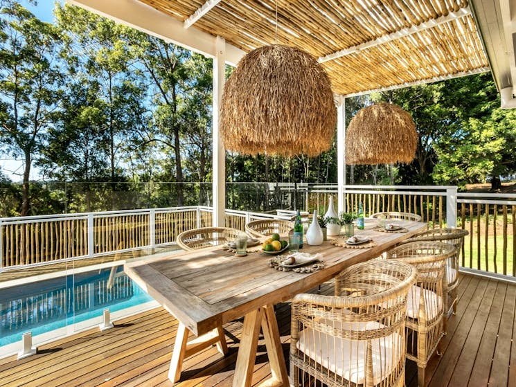 Charming outdoor poolside dining area, perfect for enjoying alfresco meals