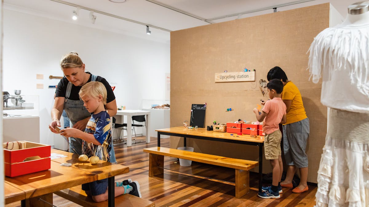 Children and adults interact with exhibition items