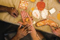 Customer holding a piece of natural ochre with Aboriginal artist