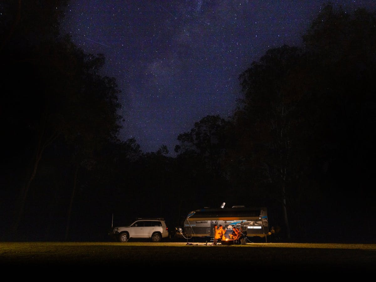 Campers camping under the stary night