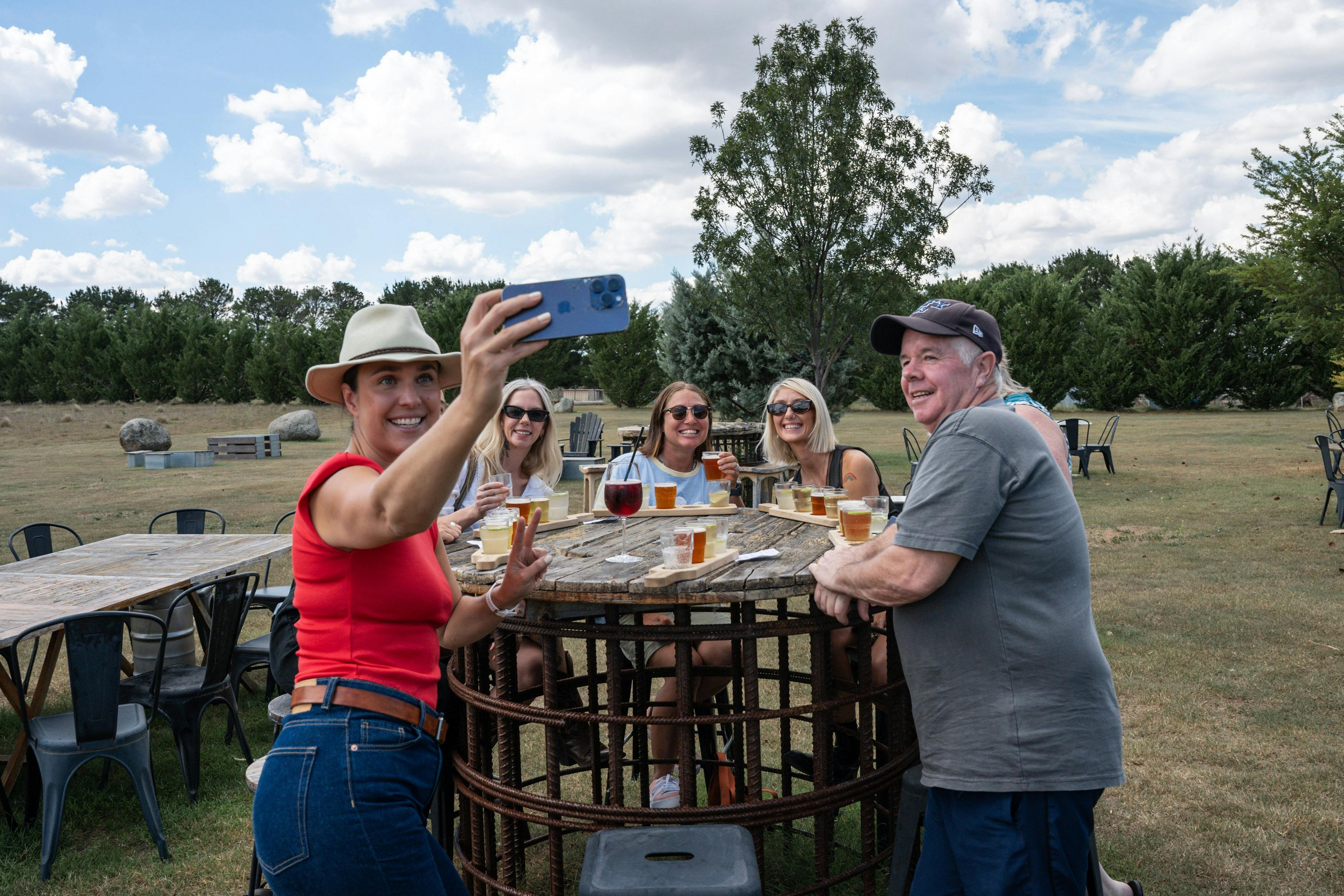 A group of tour guests with craft beer tasting paddles from Dalegty Brewery taking a selfie photo