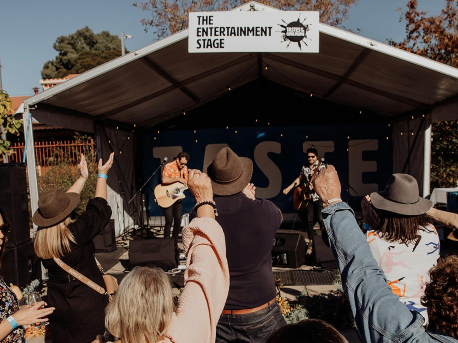 people dancing in front of live music stage