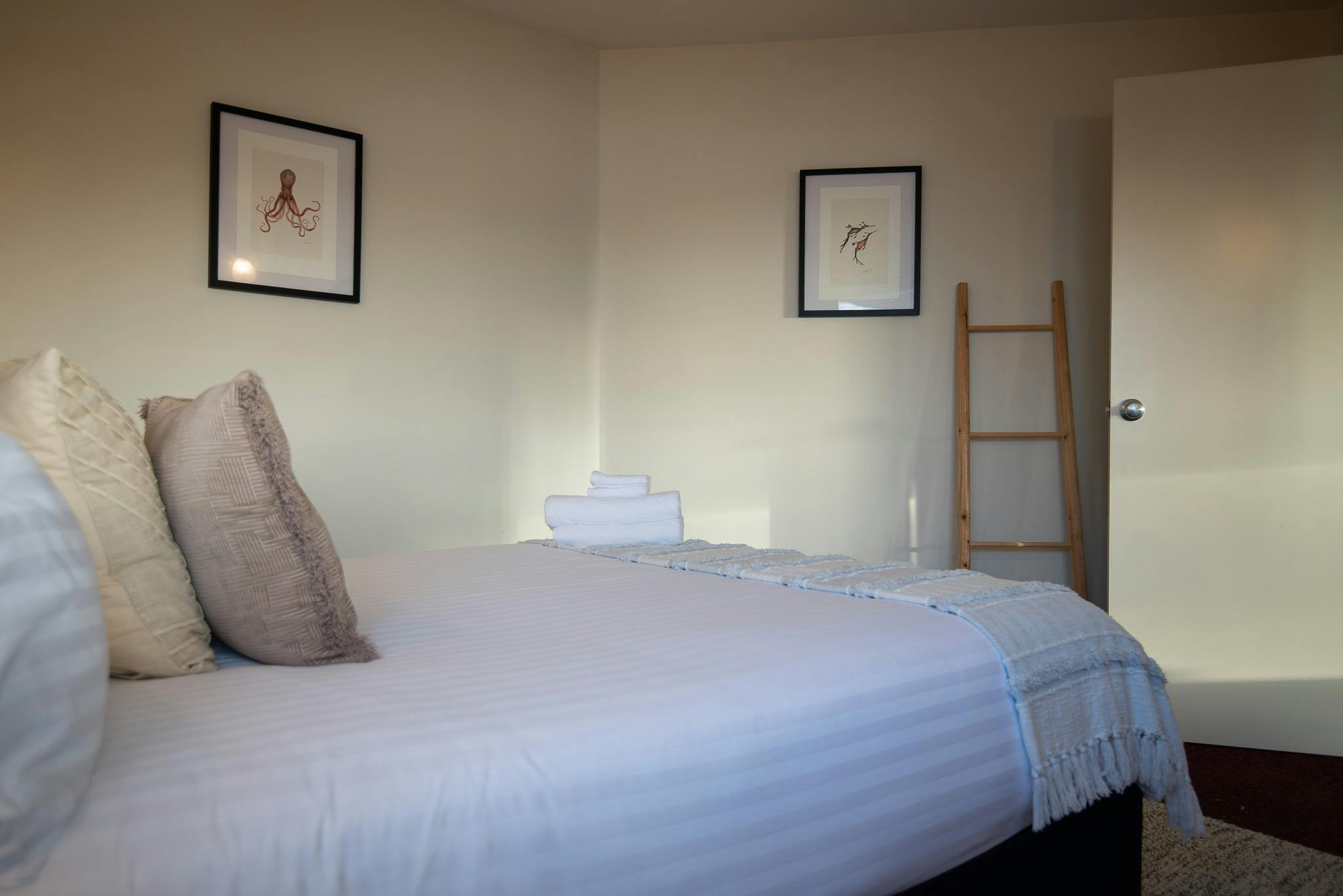 Light filled and decorated with crisp white linen drawings from local artist