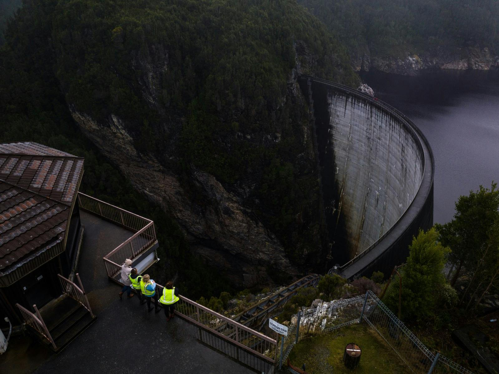 Staff on the walkway of Gordon Dam wearing High-Vis