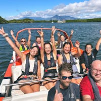 Smiling waving guests aboard Bad Fishy Jet Boat in Tropical North Queensland's Trinity Inlet