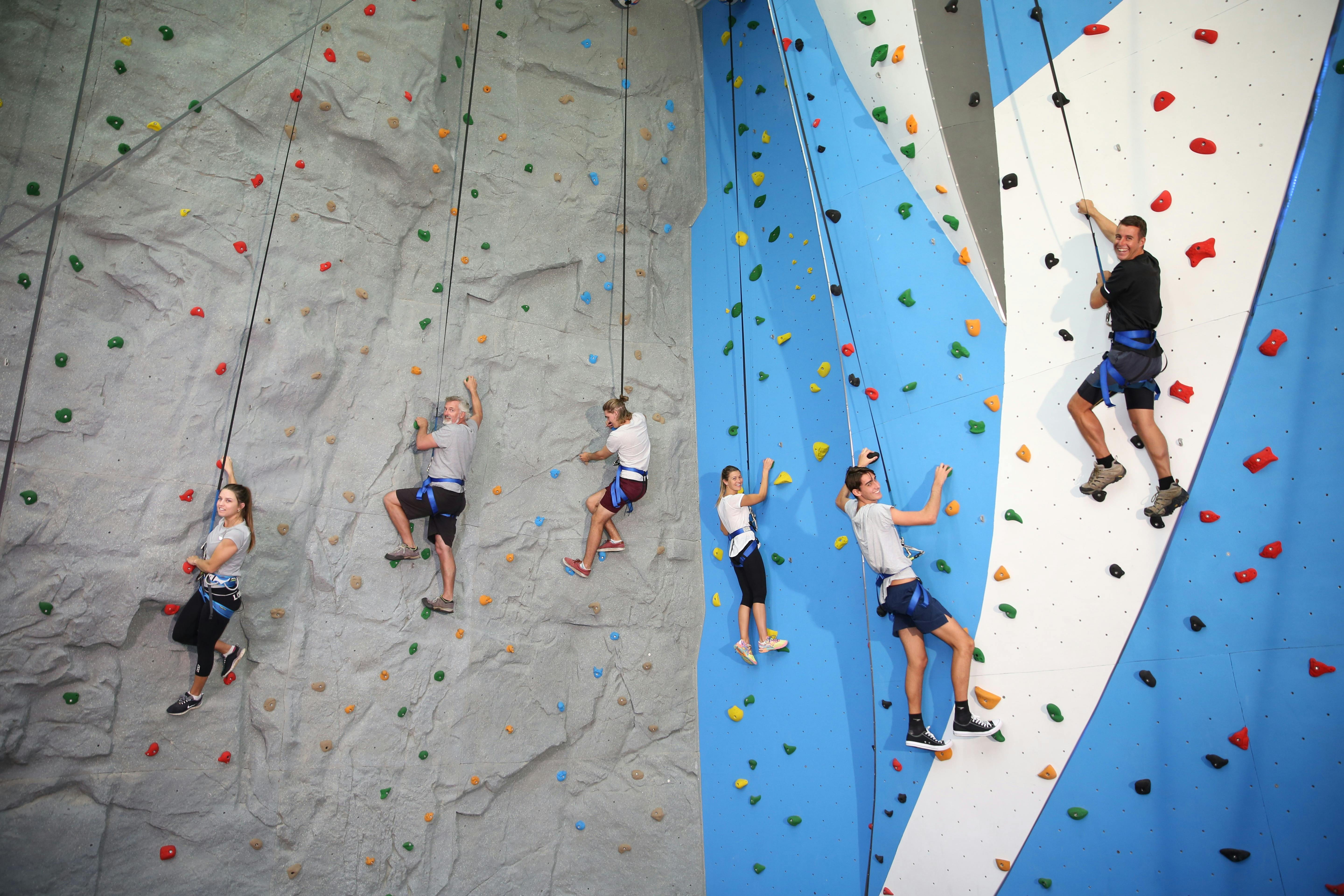 Six people scaling the rock climbing wall at Sunshine Coast Recreation Precinct