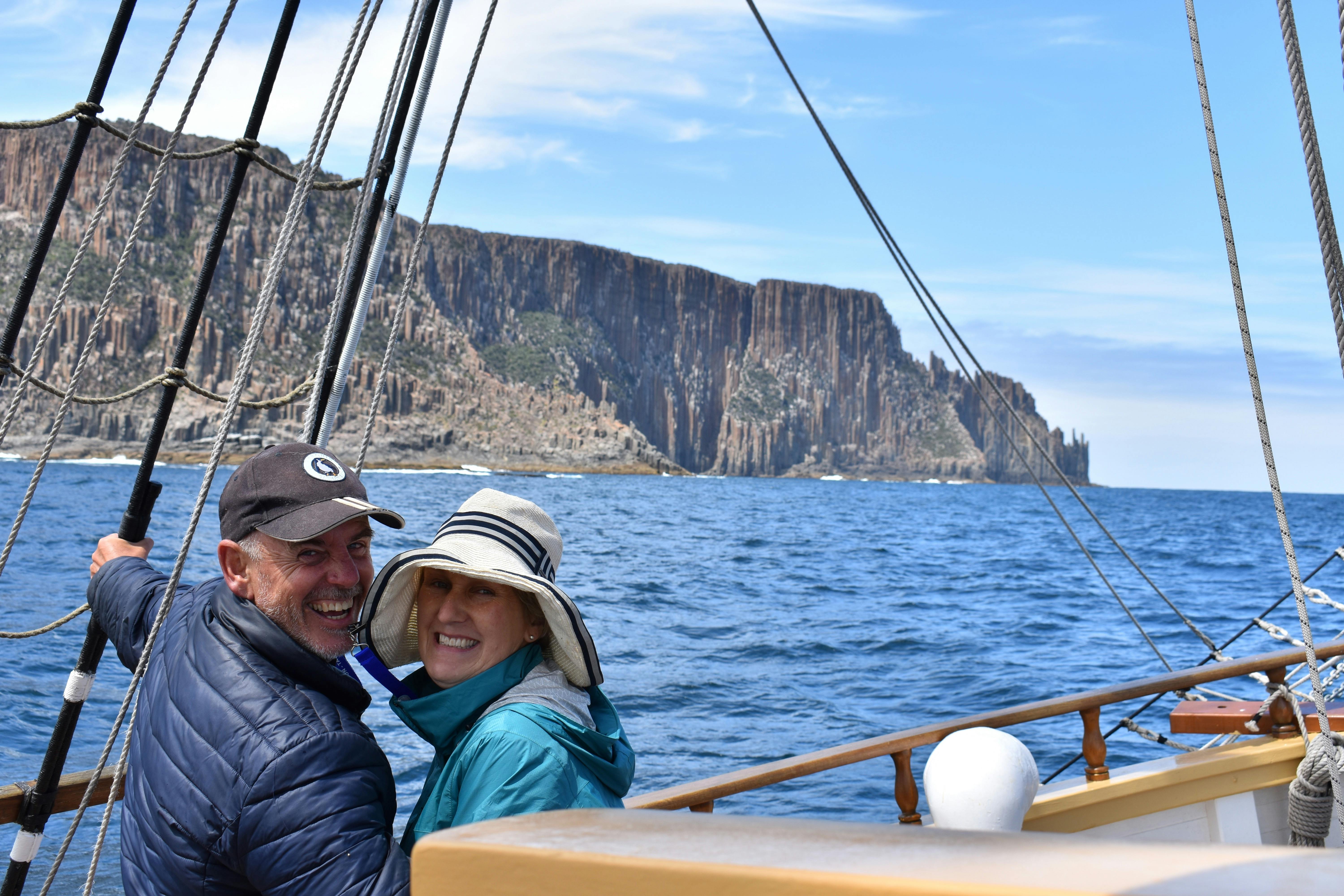 a couple enjoying spectacular scenery aboard Lady Nelson near Maria Island