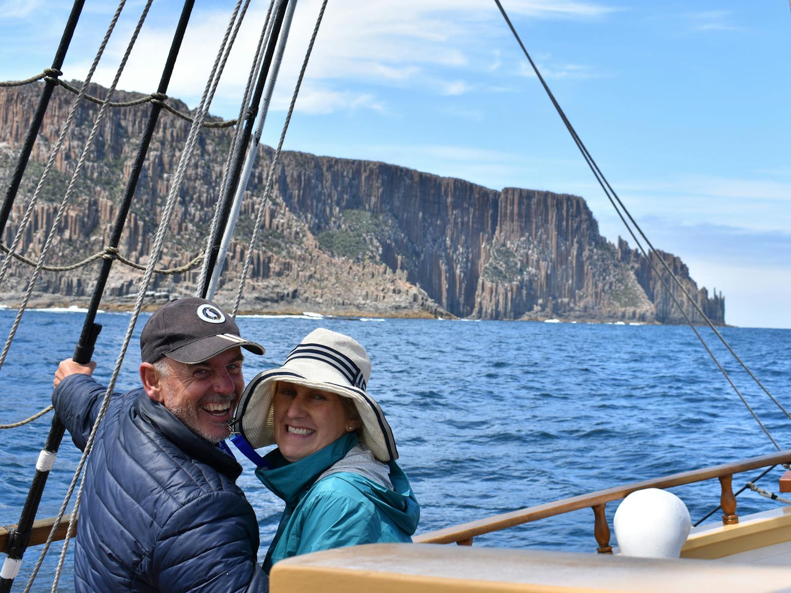 a couple enjoying spectacular scenery aboard Lady Nelson near Maria Island