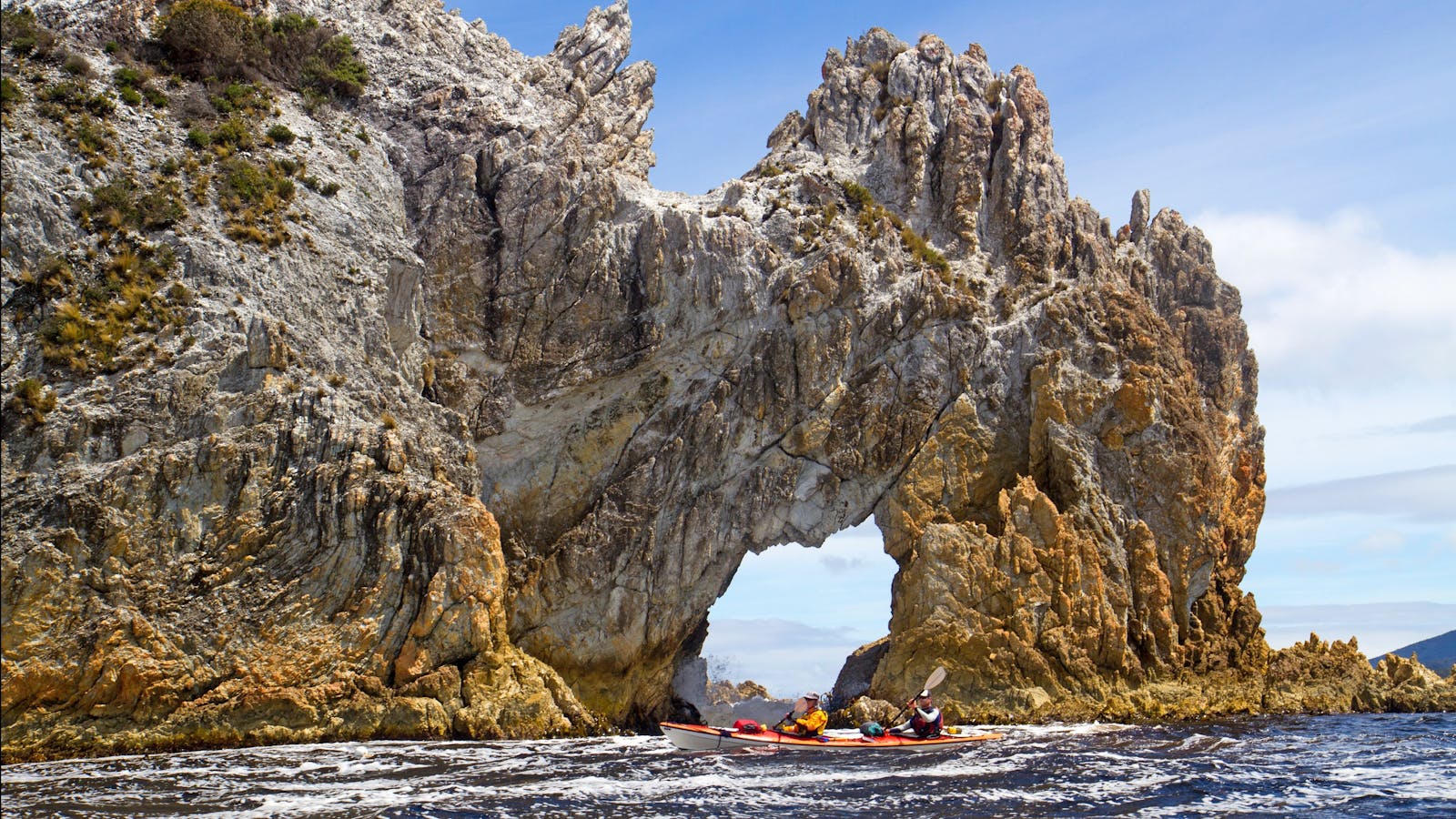 Kayakers paddling in Port Davey near Wallaby Arch