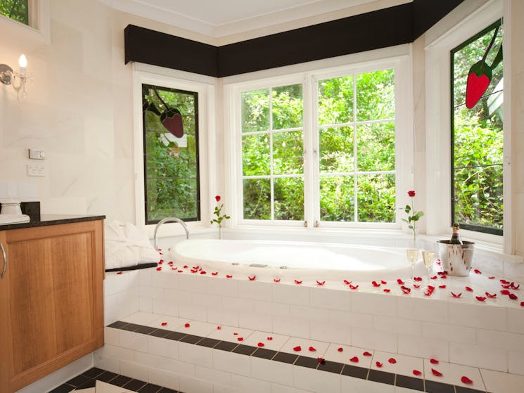 Double person spa bathroom complete with heated floor, piped music overooking private, lush garden