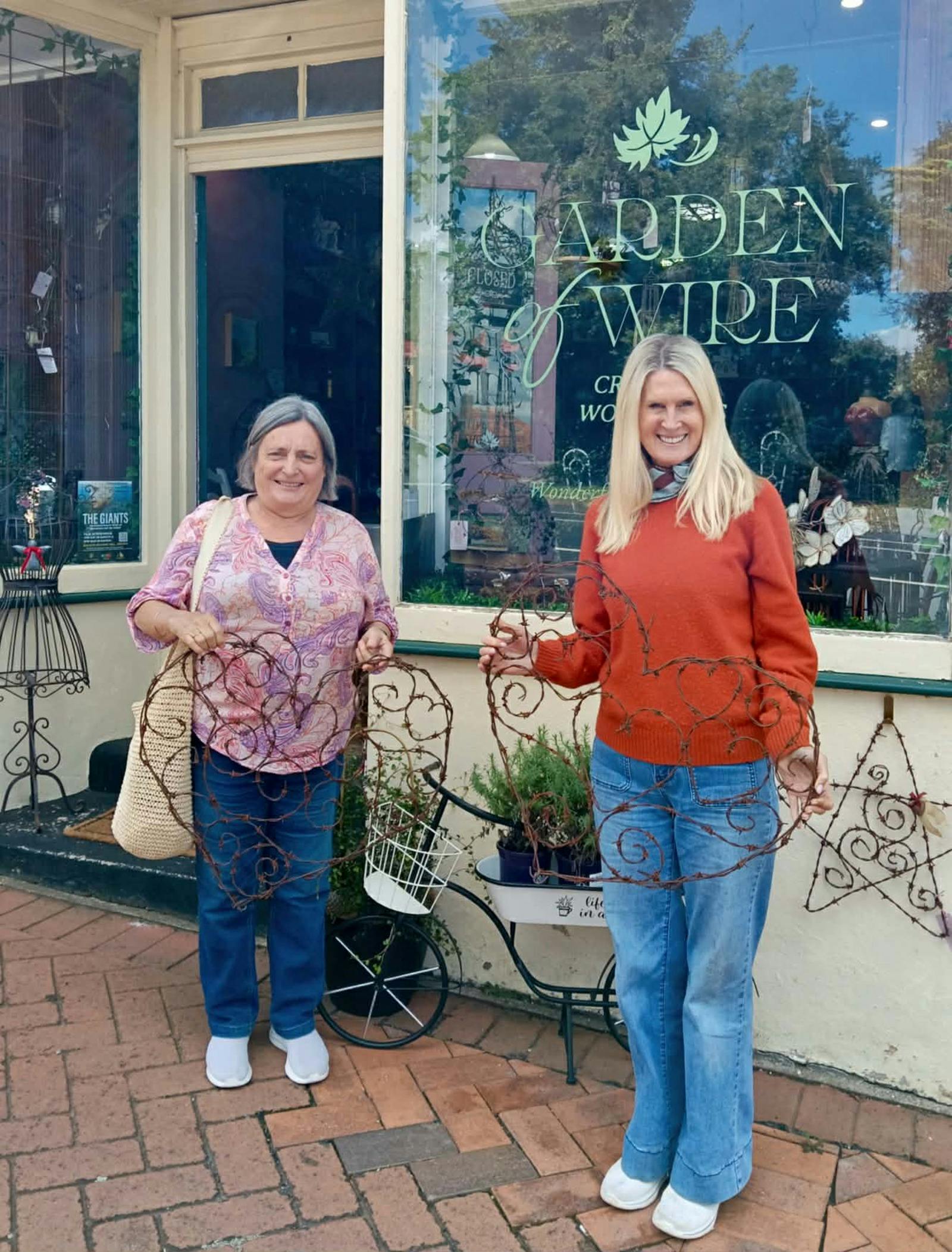 Clients standing in front of shop with Hearts of Wire
