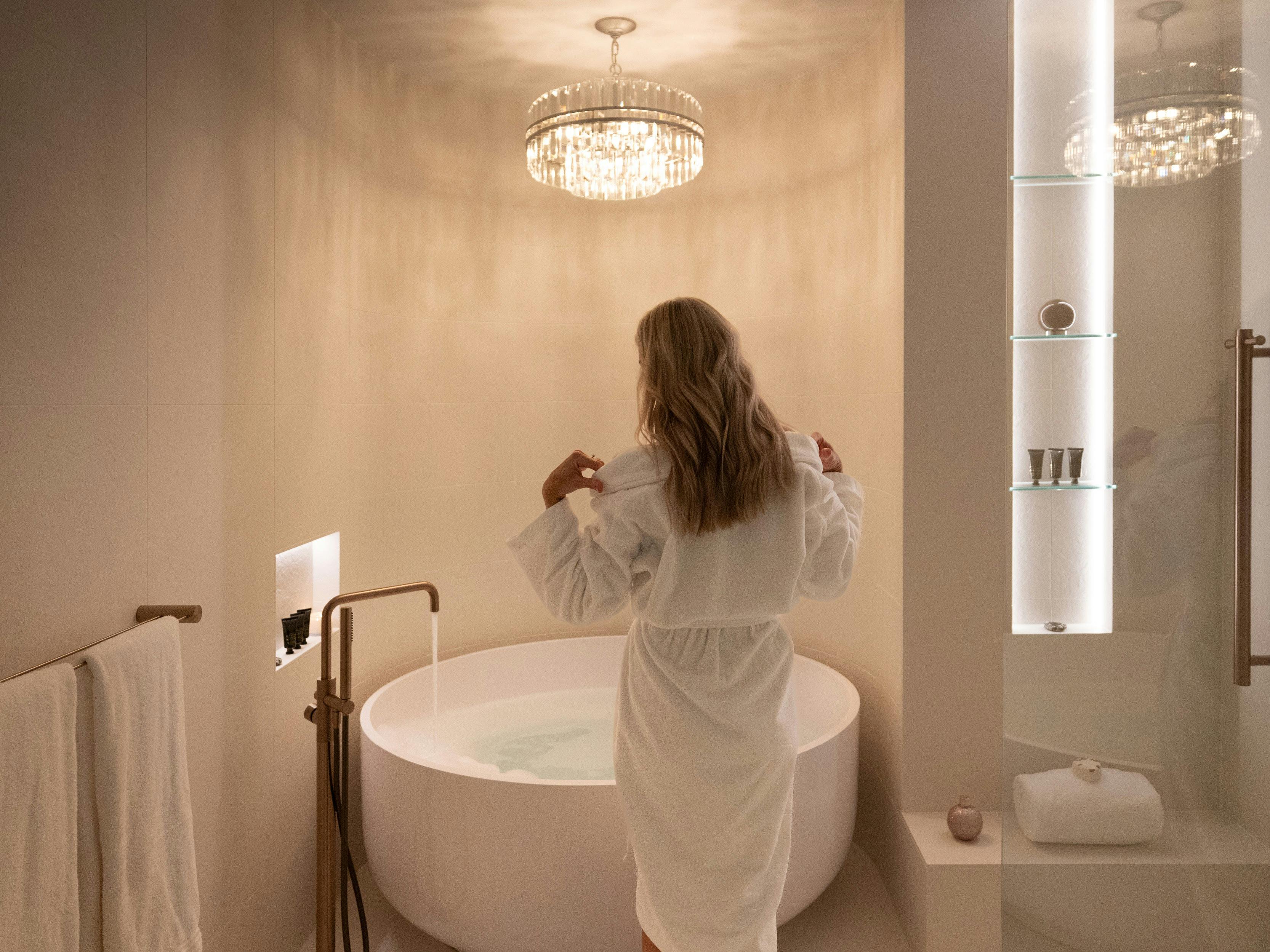 A woman is running a spa bath