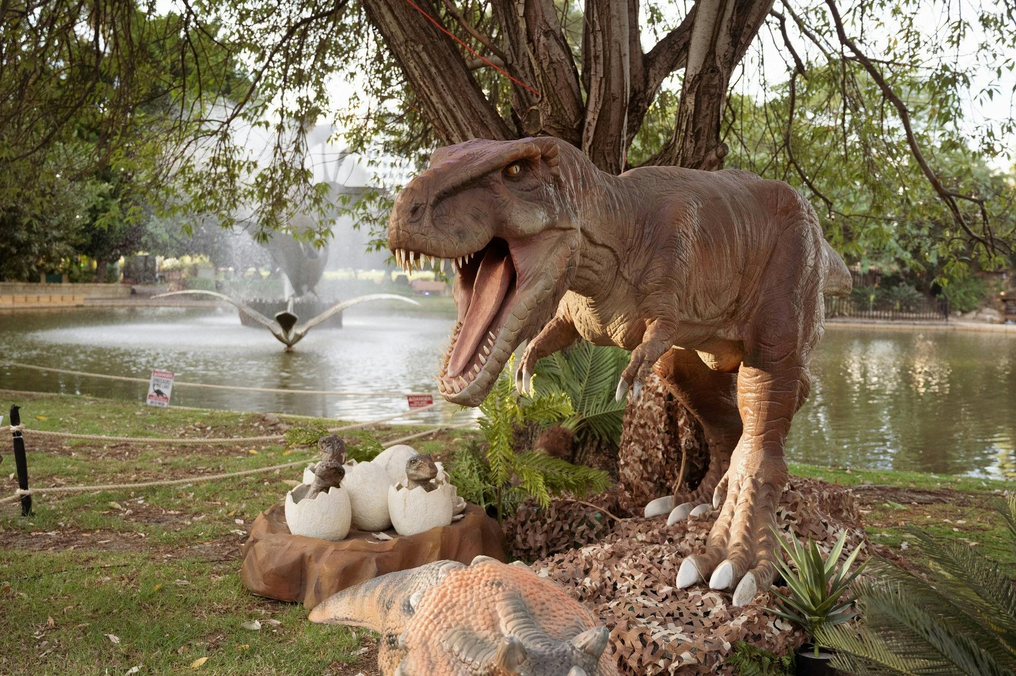 A life-size animatronic dinosaur roaring to protect it's nest.