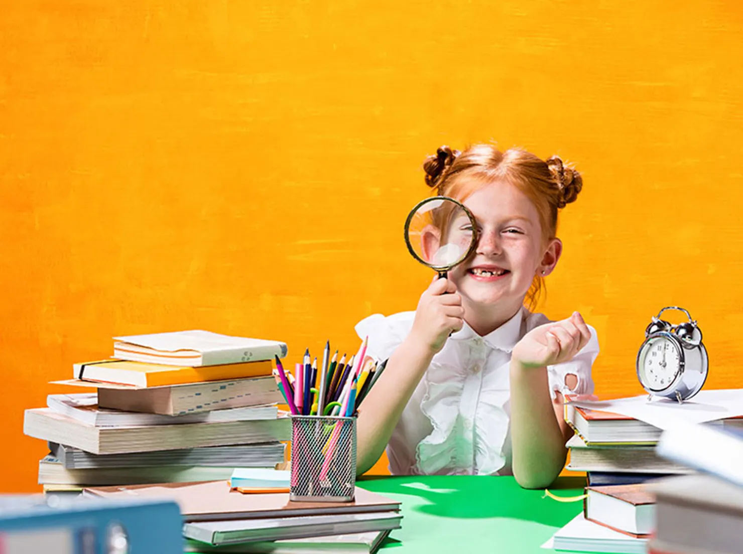 Child with magnifying glass at the Education Fair