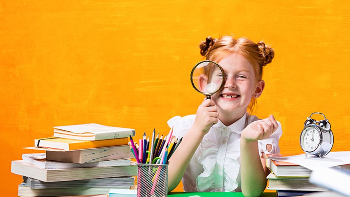 Child with magnifying glass at the Education Fair