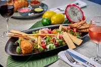 A Platter of tropical fruits, nuts, cheeses and cured meats
