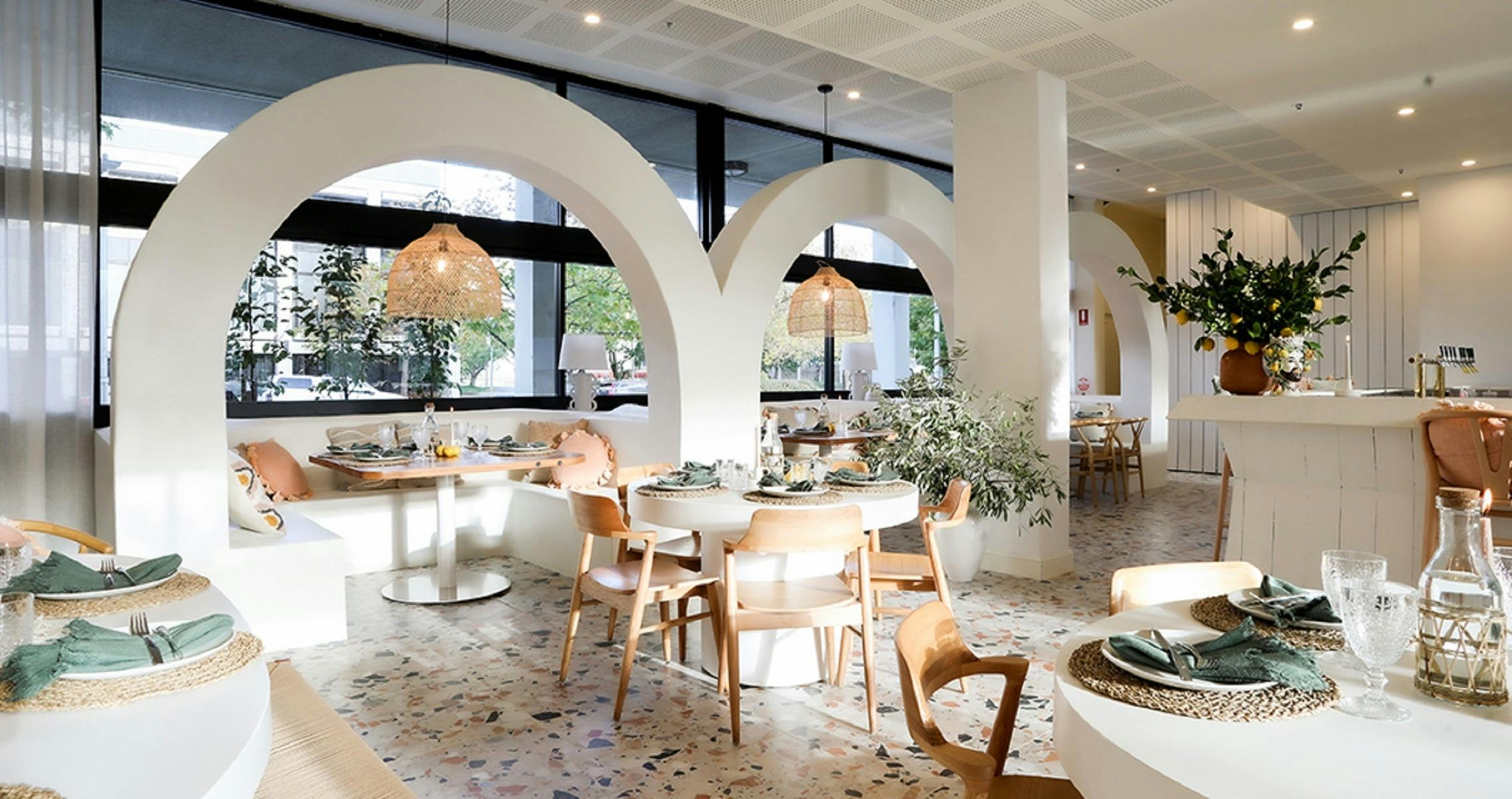 Interior of restaurant with white and brown tables and chairs