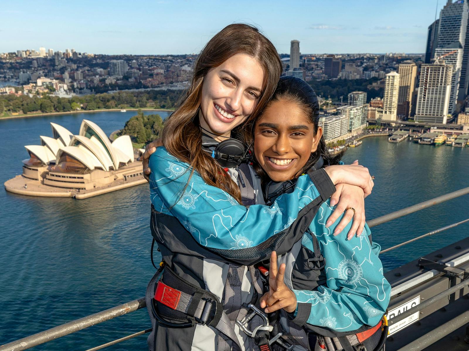 2 friends at the Summit of the Sydney Harbour Bridge with Sydney Opera House in background