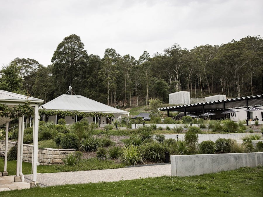 View of the pathway and green planting leading to the Visitor Services Office & Art Museum