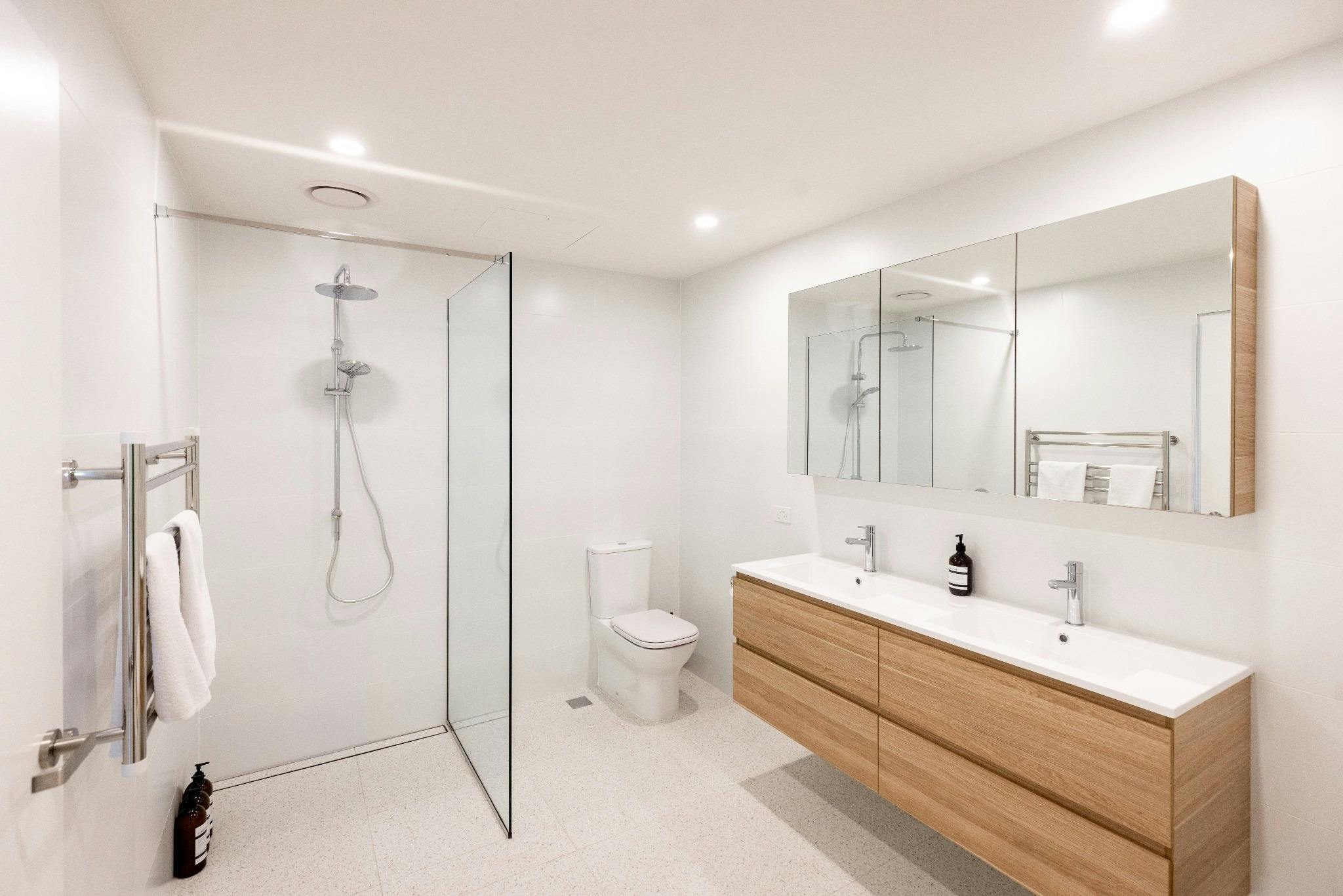 Modern ensuite bathroom featuring a double vanity, walk-in shower and premium finishes throughout