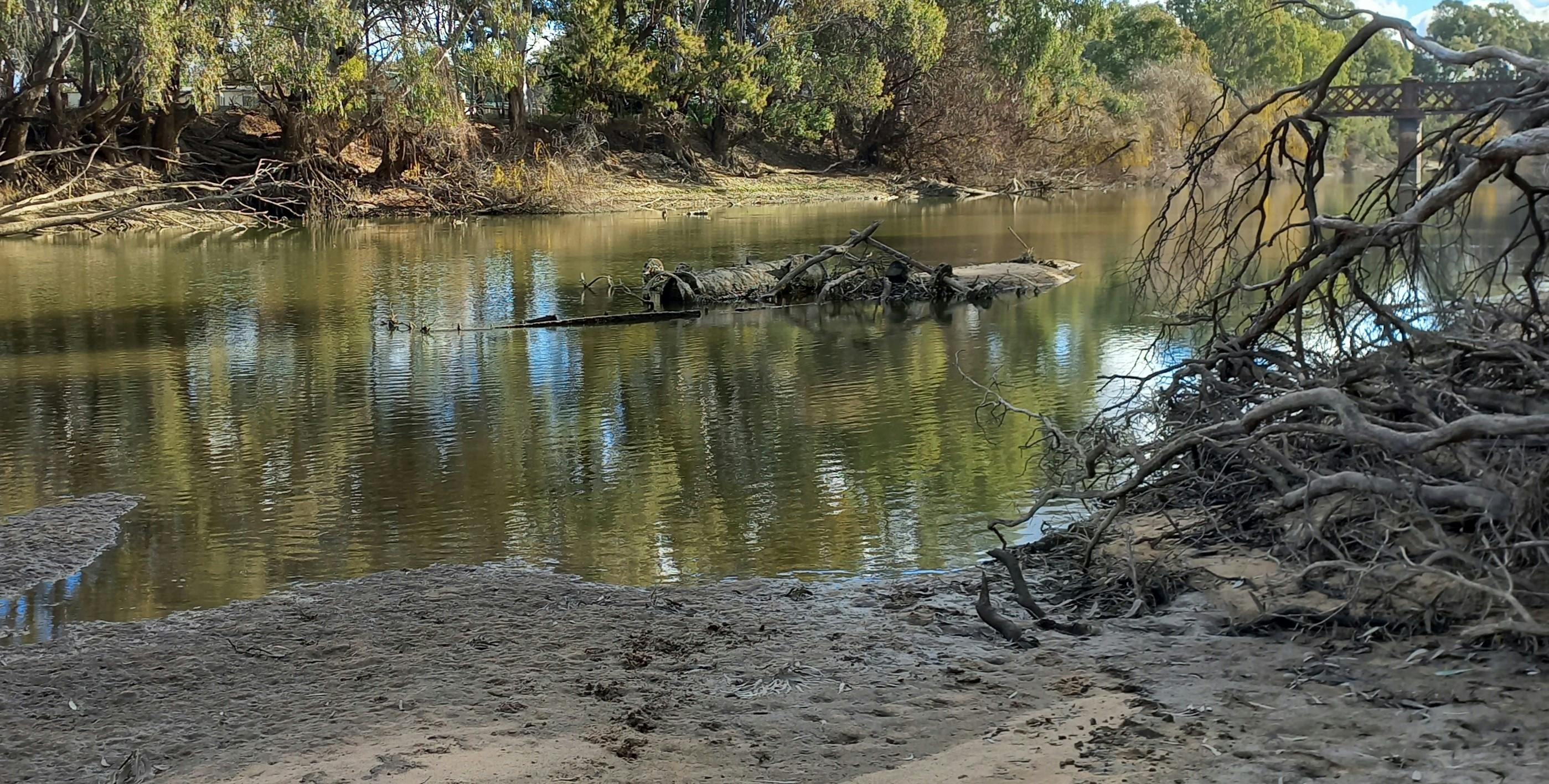 The rusted remains of the boiler and wheel axel of the PS Wagga Wagga buried in the river-bed.