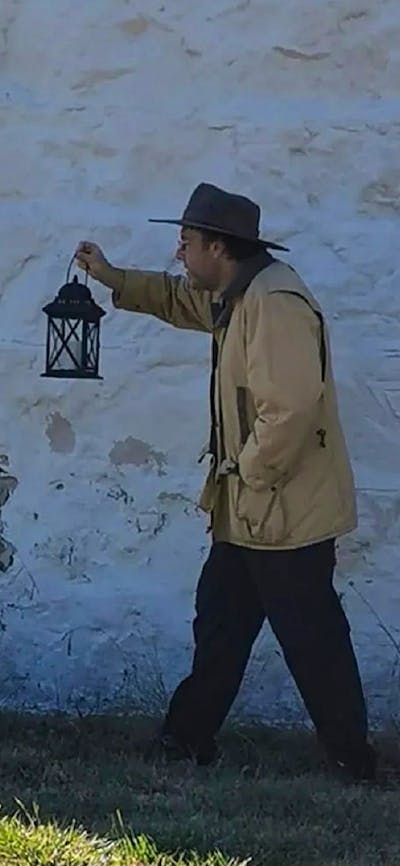 Man holding an oil lamp