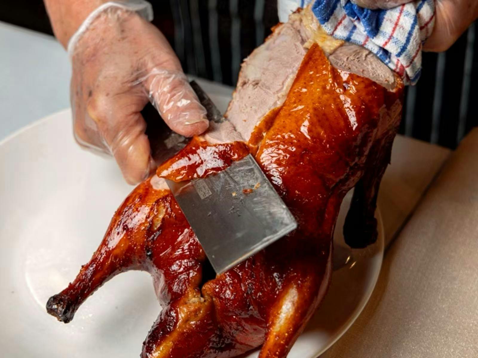 chef carving signature peking duck at Ming Dining Melbourne