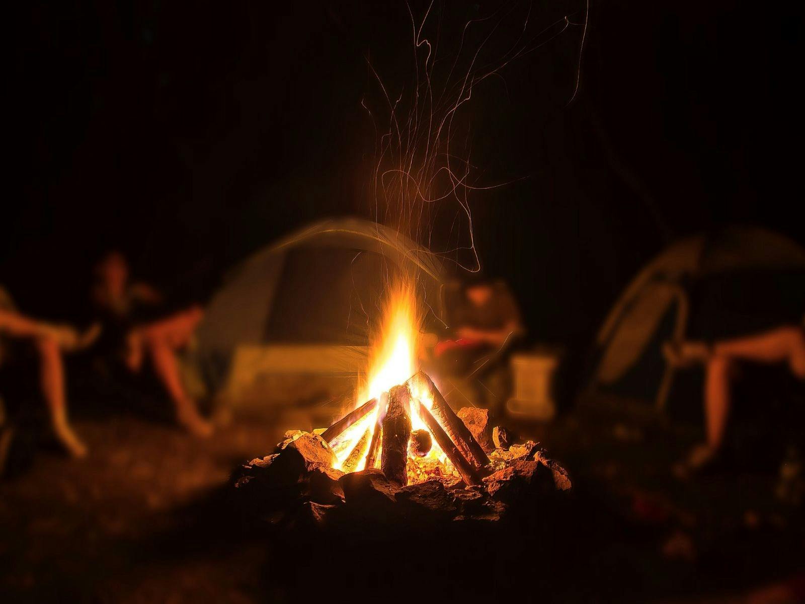 people sitting around a campfire sharing stories