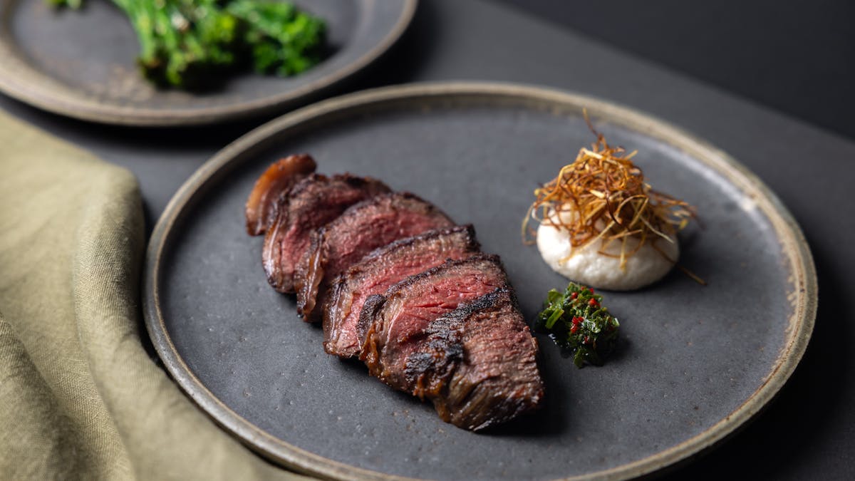 Wagyu rump cap 8+, herb sauce, alliums