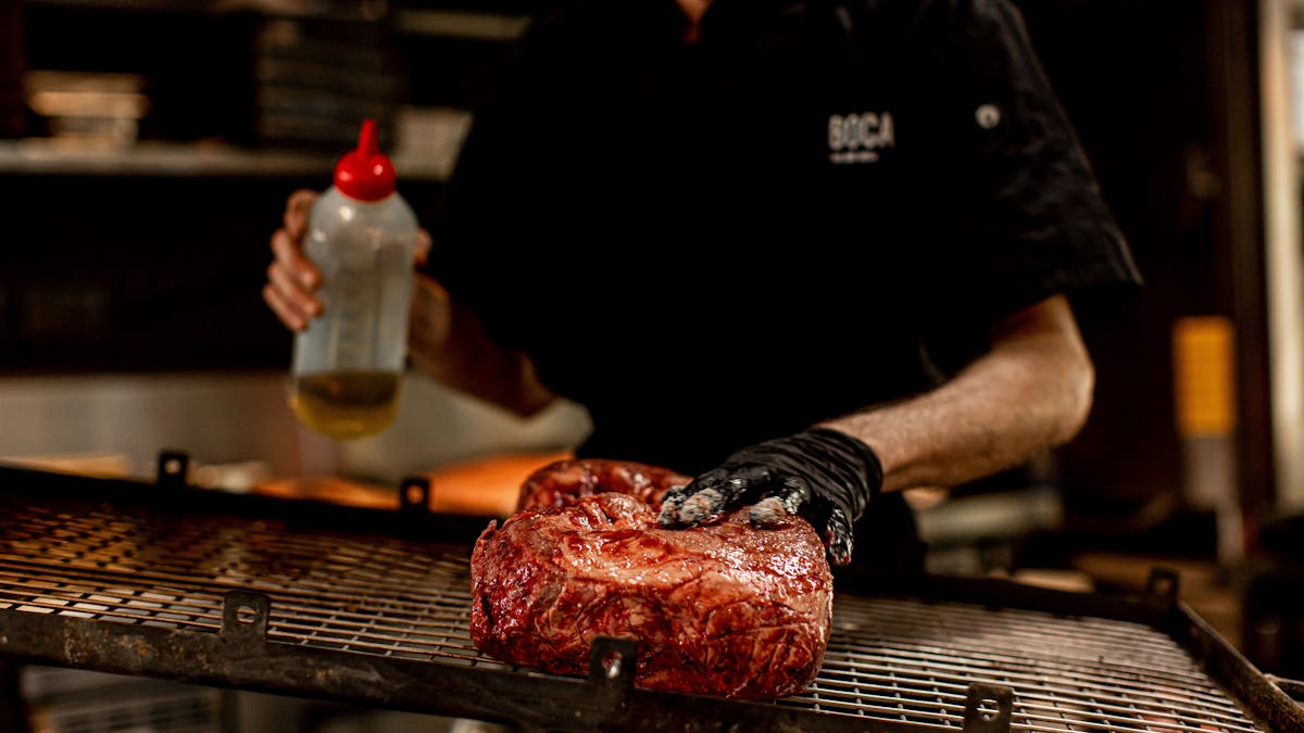 Chef preparing meat on the asador