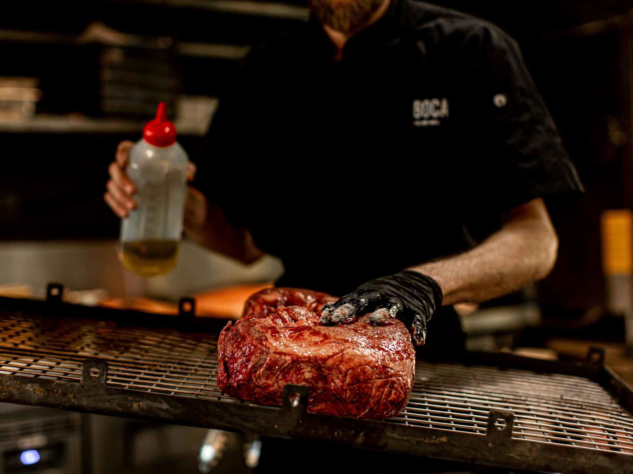 Chef preparing meat on the asador Chef preparing meat on the asador