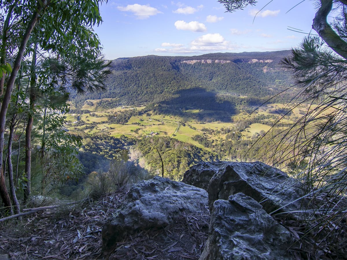 The view of a valley of farmland and Australian forest