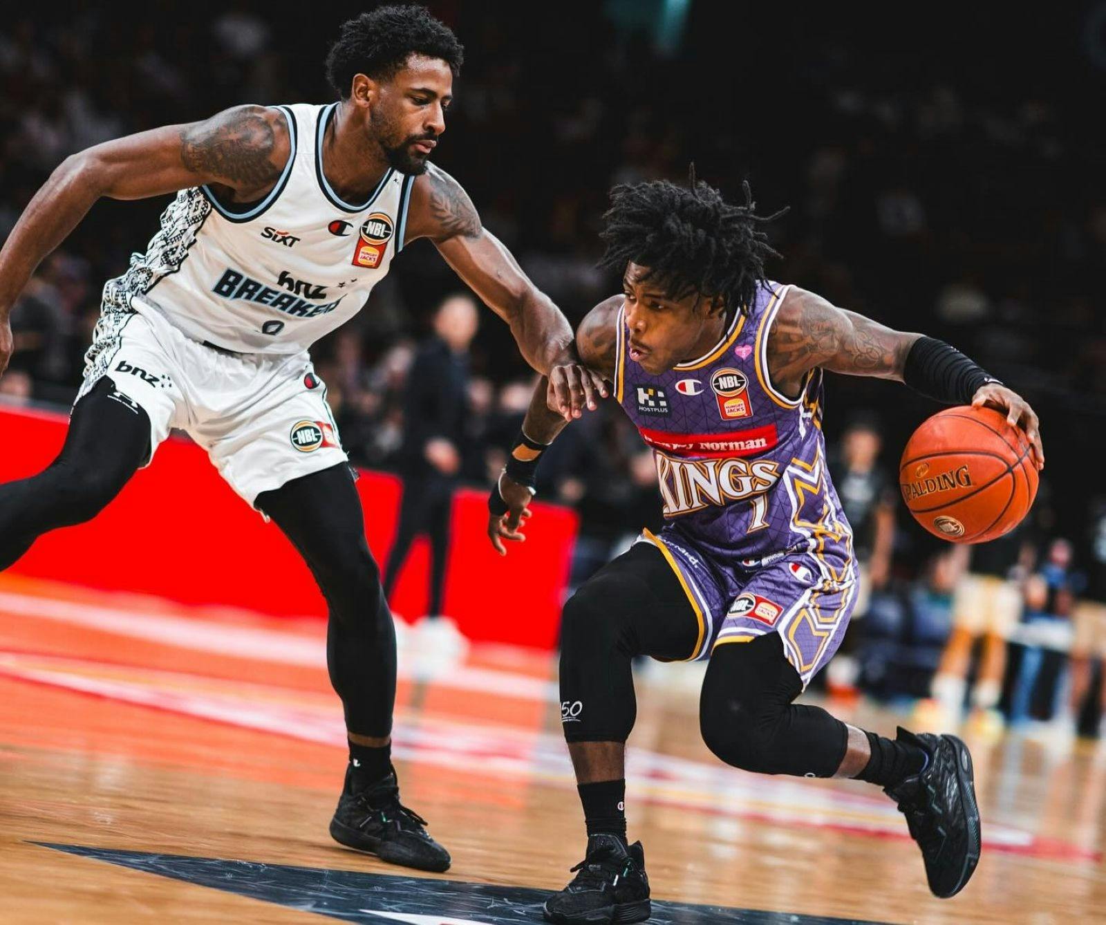 Sydney Kings player and opponent on court